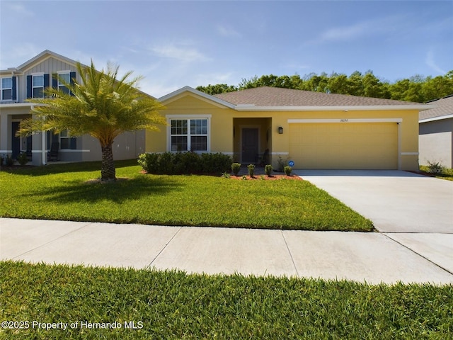 view of front of home with a garage and a front lawn