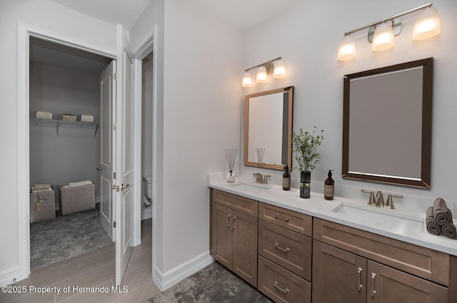 bathroom featuring tile patterned floors, vanity, and toilet