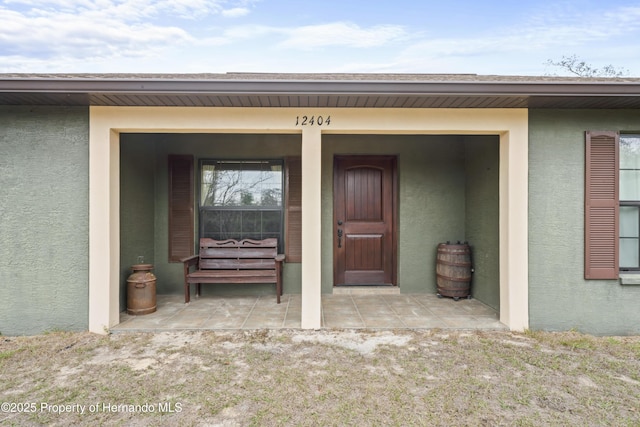 doorway to property with a patio