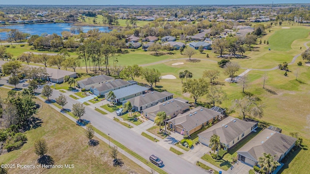 bird's eye view with view of golf course, a water view, and a residential view