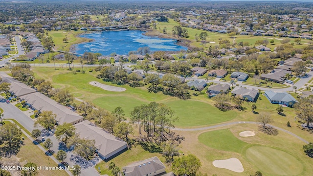 aerial view featuring a residential view, golf course view, and a water view