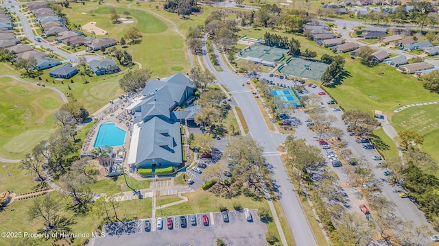 drone / aerial view featuring golf course view and a residential view