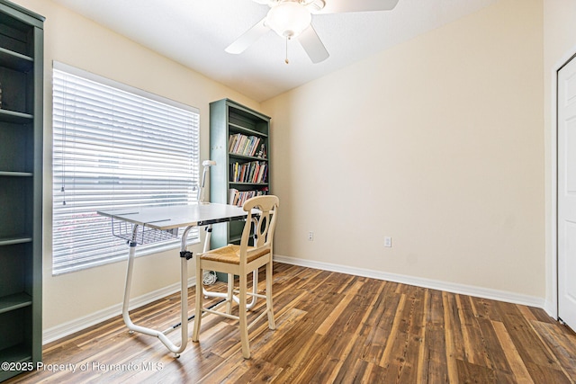 office featuring baseboards, a healthy amount of sunlight, wood finished floors, and a ceiling fan