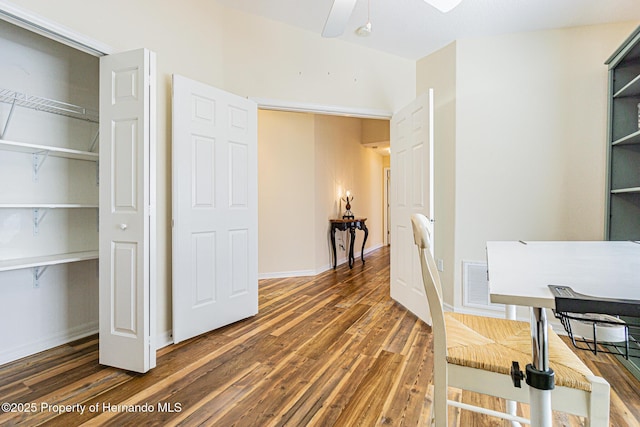 office area featuring ceiling fan, visible vents, baseboards, and wood finished floors