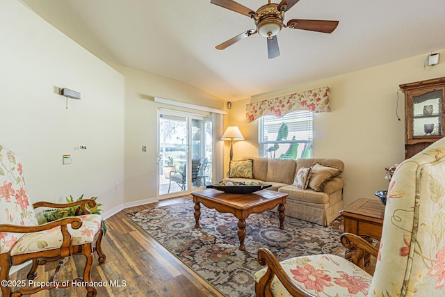 living room with vaulted ceiling, plenty of natural light, ceiling fan, and wood finished floors