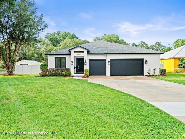 view of front of house featuring a garage and a front yard