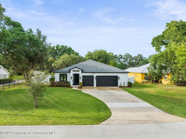 view of front facade with a garage and a front lawn