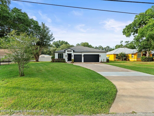 ranch-style home featuring a front lawn and a garage