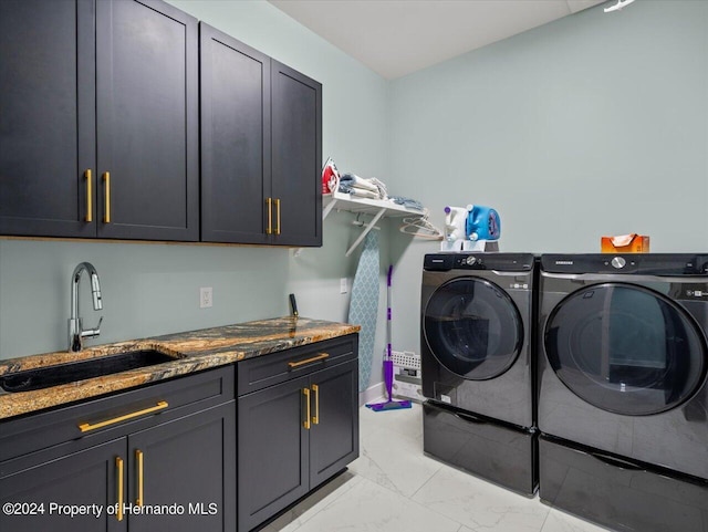 laundry area with cabinets, independent washer and dryer, and sink