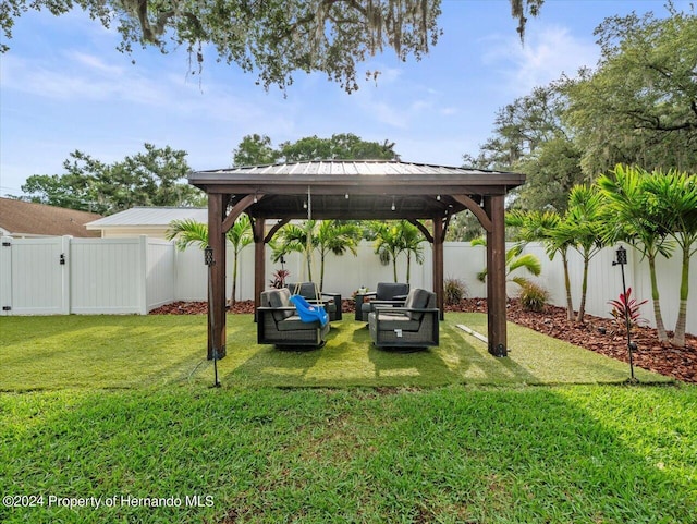 view of yard with outdoor lounge area and a gazebo