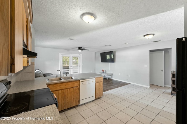 kitchen featuring dishwasher, sink, ceiling fan, range with electric stovetop, and light tile patterned flooring