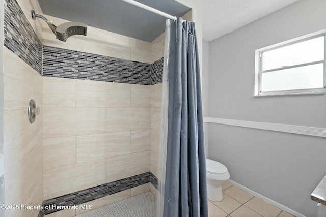 bathroom featuring a shower with shower curtain, tile patterned flooring, toilet, and a textured ceiling