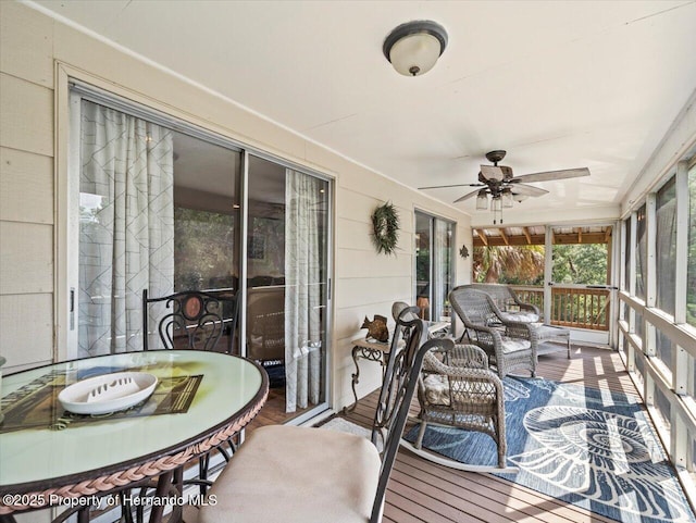 sunroom / solarium featuring ceiling fan