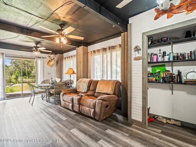 living room featuring hardwood / wood-style floors and ceiling fan