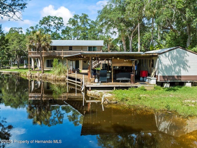 rear view of house featuring a water view