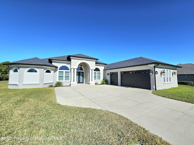 view of front of property with a garage and a front lawn