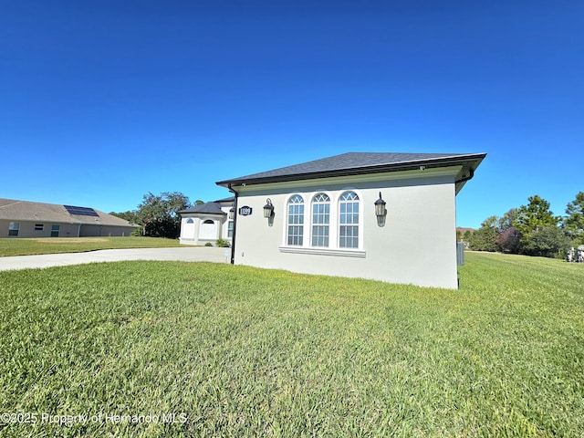 view of side of home featuring a lawn