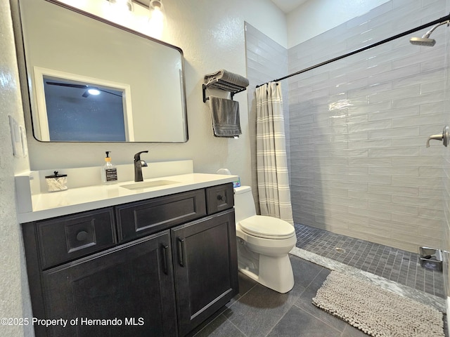 bathroom with a shower with curtain, vanity, toilet, and tile patterned flooring