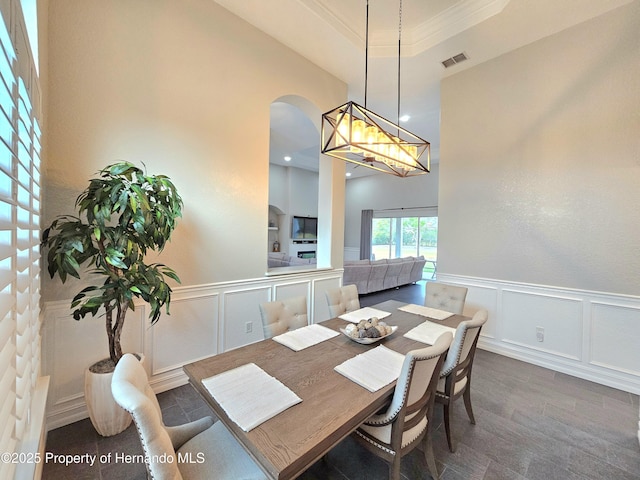 dining area featuring dark hardwood / wood-style flooring and ornamental molding