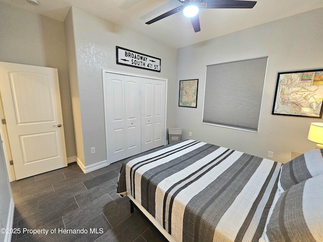 bedroom featuring ceiling fan and a closet