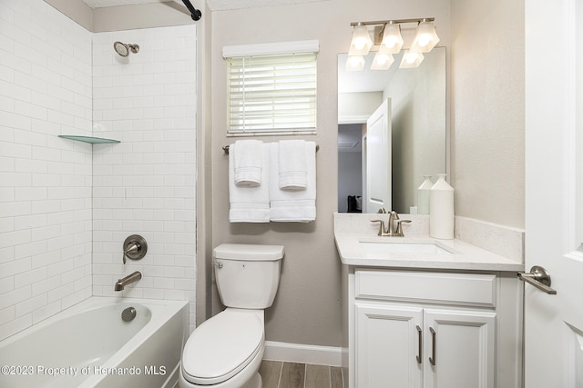 full bathroom with vanity, tiled shower / bath combo, and toilet