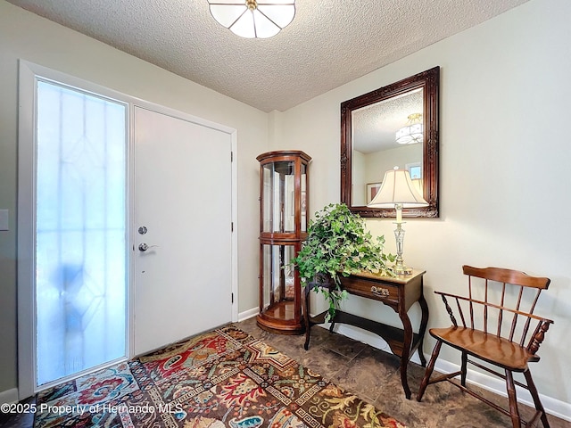 foyer entrance with a textured ceiling