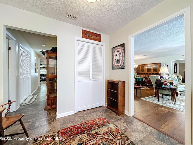 hallway with a textured ceiling