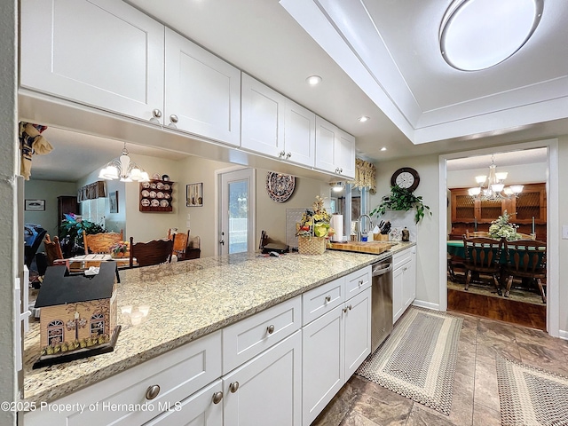 kitchen featuring decorative light fixtures, dishwasher, light stone counters, and white cabinetry