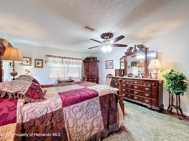 bedroom featuring a textured ceiling, ceiling fan, and carpet flooring