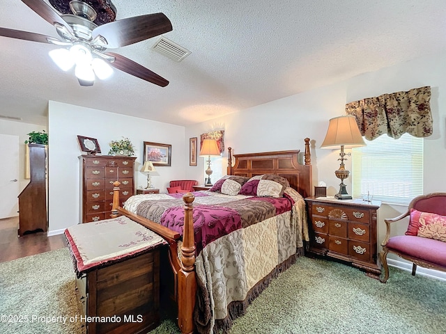 bedroom with carpet flooring, a textured ceiling, and ceiling fan