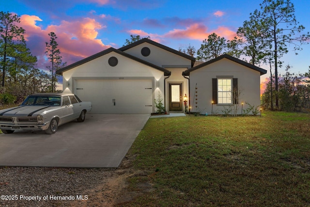 view of front of home with a yard and a garage