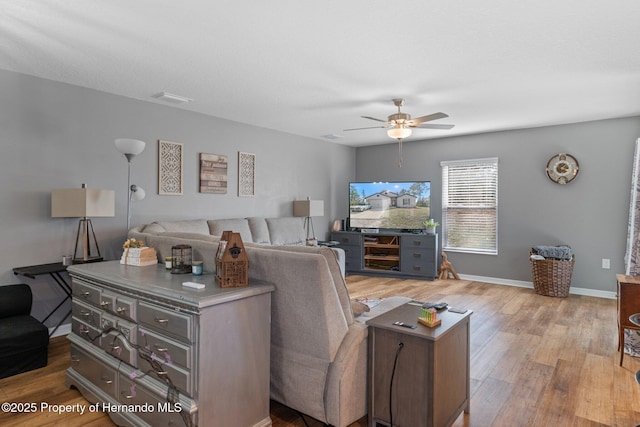 living room featuring light hardwood / wood-style floors and ceiling fan