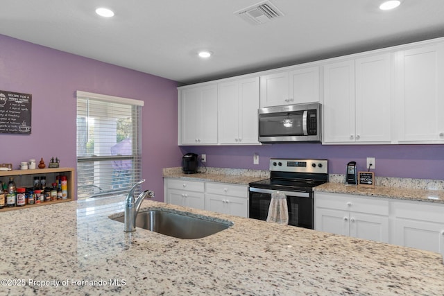 kitchen featuring white cabinets, sink, and stainless steel appliances