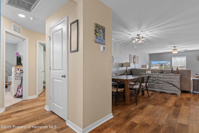 corridor featuring hardwood / wood-style floors and a textured ceiling