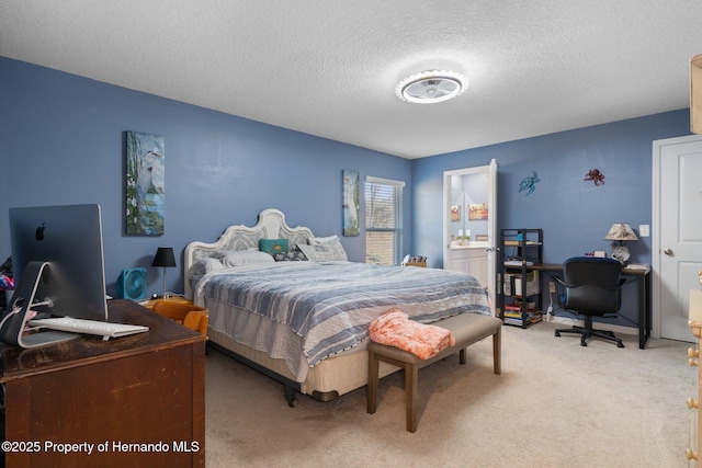 bedroom with carpet and a textured ceiling