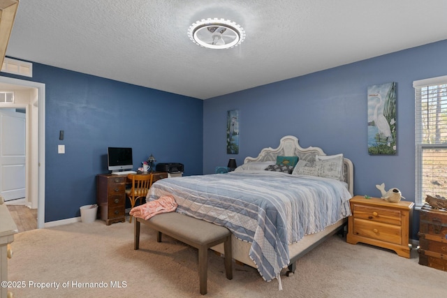 carpeted bedroom with a textured ceiling