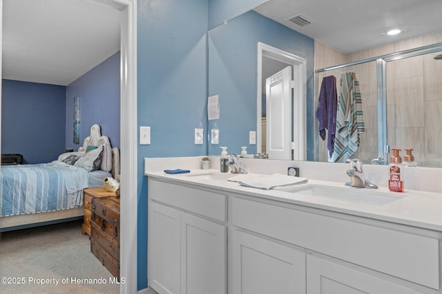 bathroom with vanity and a shower with shower door