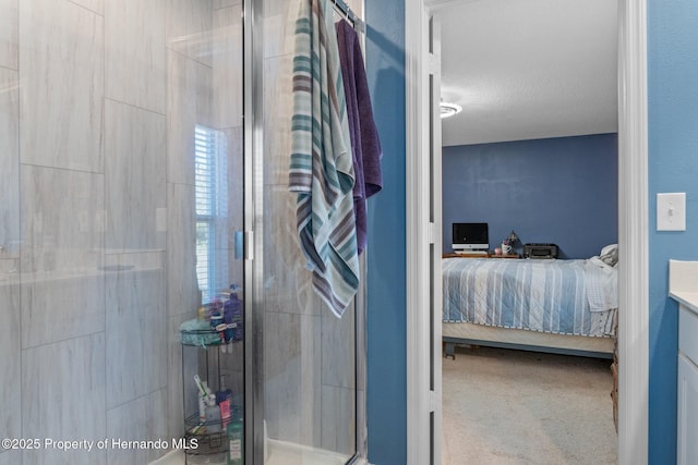 bathroom featuring a textured ceiling, vanity, and walk in shower