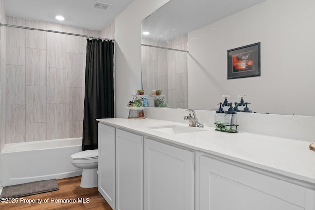 full bathroom with wood-type flooring, vanity, toilet, and shower / tub combo with curtain