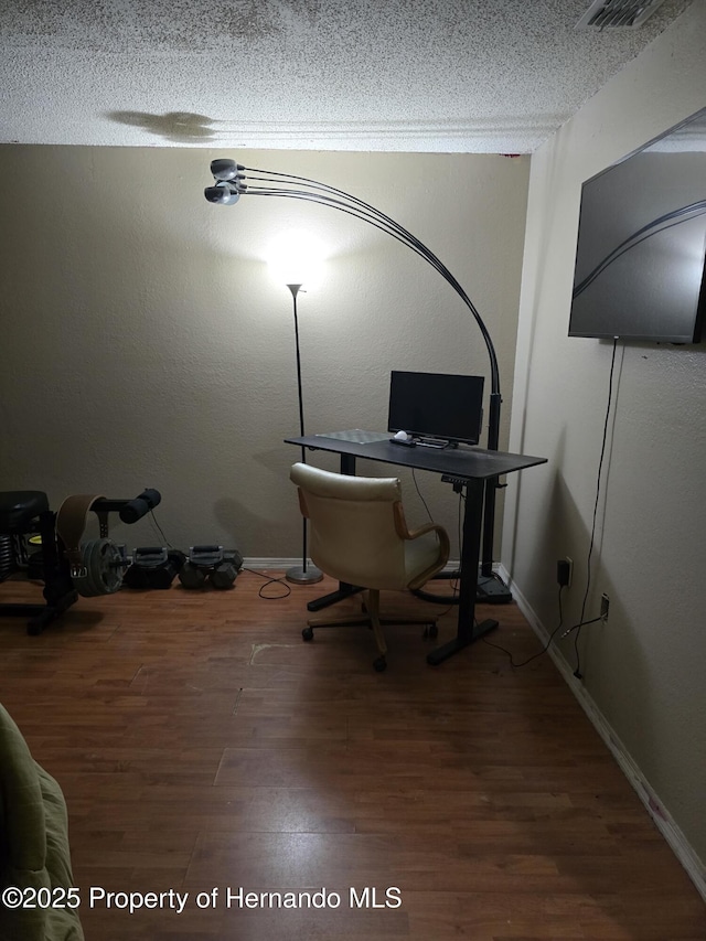 office space featuring hardwood / wood-style flooring and a textured ceiling