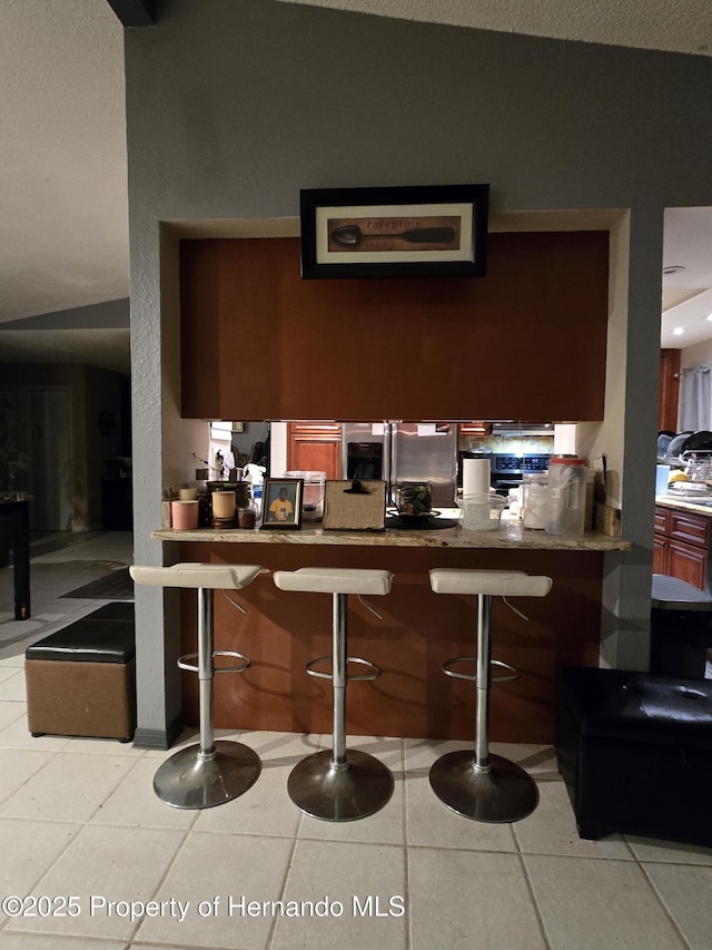 bar with light tile patterned flooring