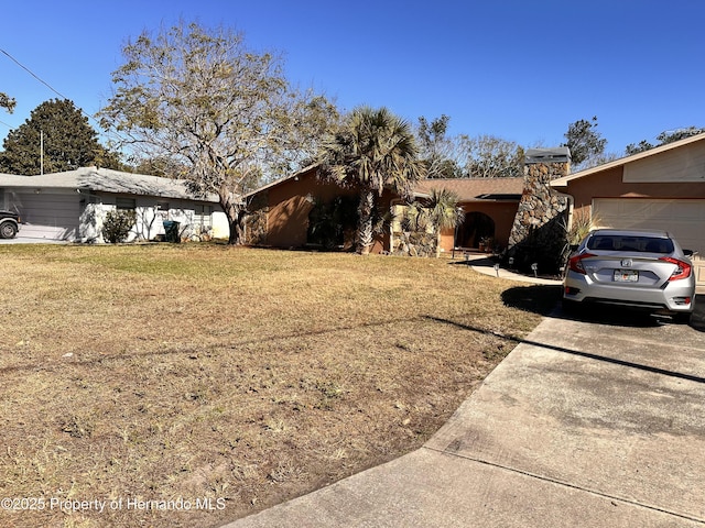 view of front facade featuring a garage and a front lawn