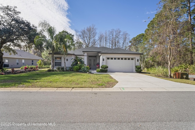 view of front of home with a garage and a front lawn