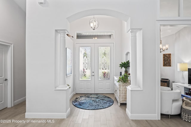 foyer entrance featuring french doors and a notable chandelier