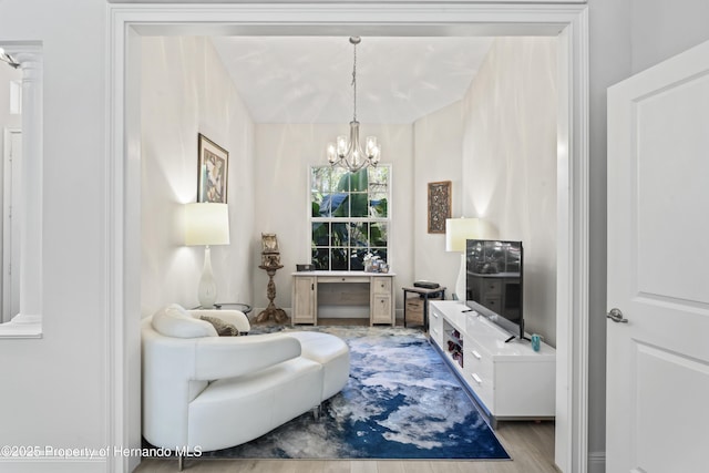 living room with light hardwood / wood-style floors and a chandelier