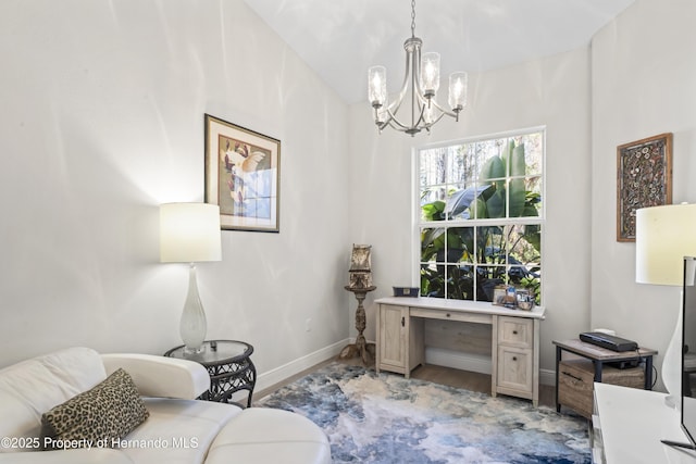 home office featuring a notable chandelier and light hardwood / wood-style flooring