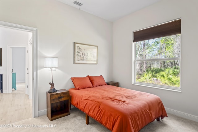 bedroom featuring light colored carpet