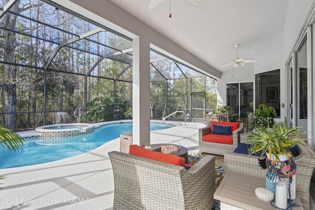 view of pool featuring glass enclosure, an outdoor hangout area, ceiling fan, an in ground hot tub, and a patio area