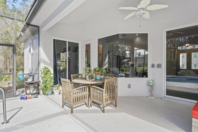 sunroom / solarium featuring ceiling fan