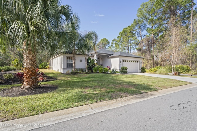 view of front of property featuring a front yard and a garage